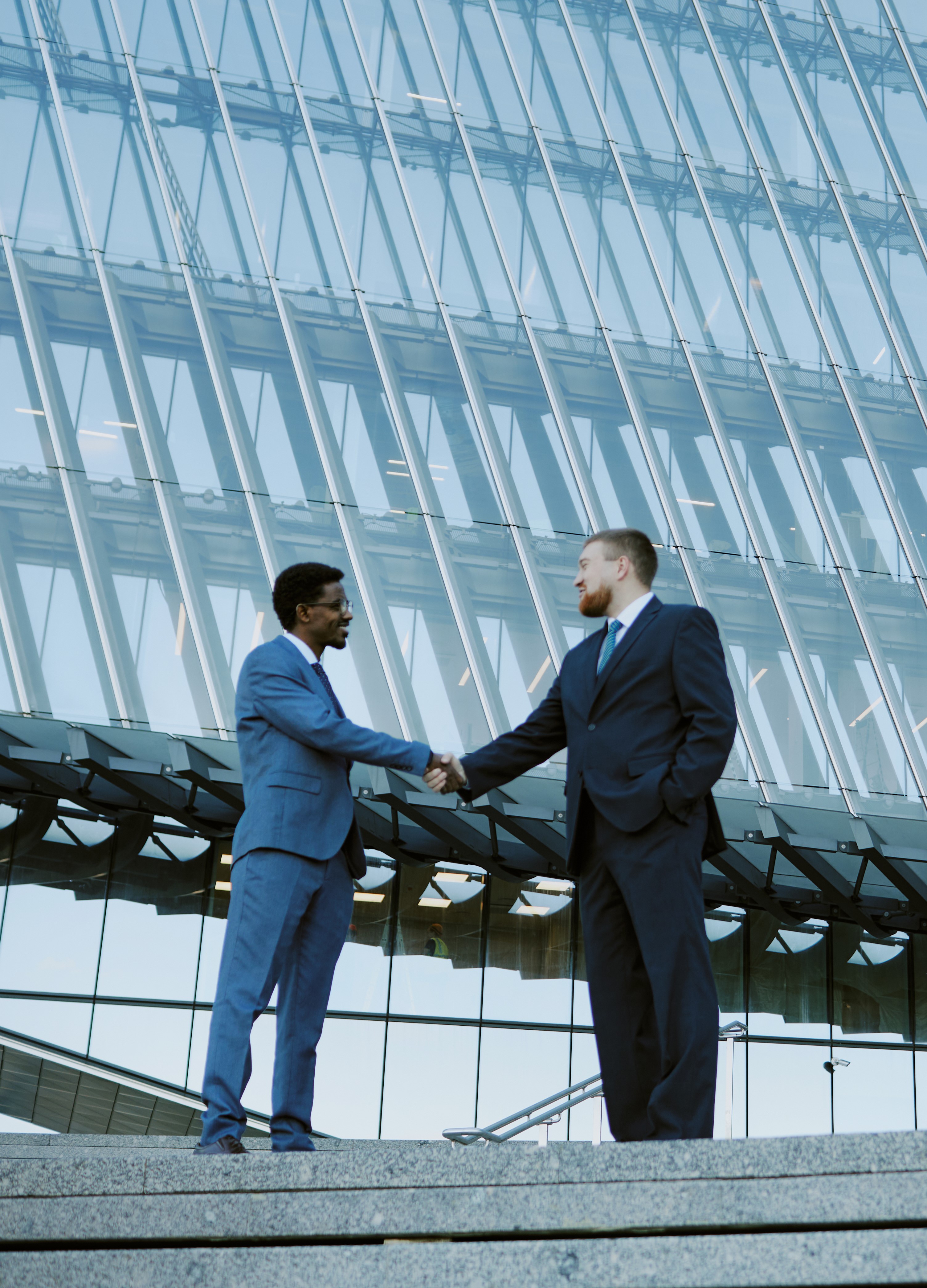 Business professionals shaking hands in modern building